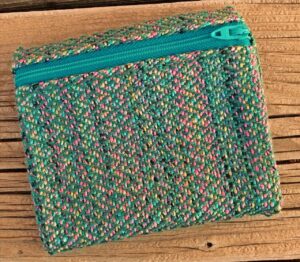 Small handwoven bag in shiny jewel tones.