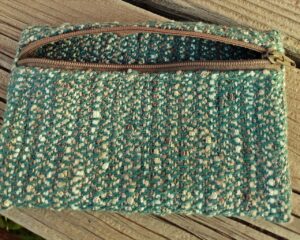 Small handwoven zippered bag in shades of bayberry and champagne